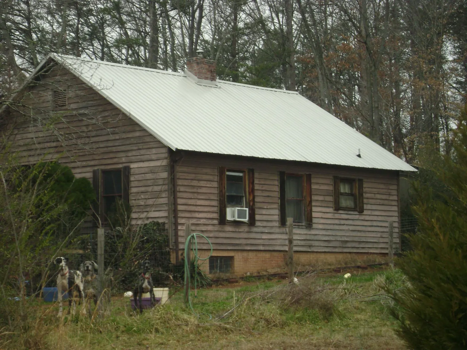 White metal roof on an old wood sided farmhouse, from a Metal Roof Installation job in Homestead